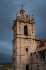 Fototapeta na wymiar old gothic style catholic church front view with a dramatic sky in palencia, spain