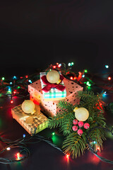 Christmas gifts with a branch of a Christmas tree. Glowing garland. Christmas. New year.