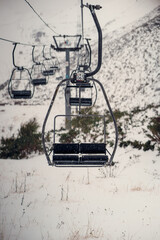 Chairlift in a snowing day at the ski resort. Asturias.