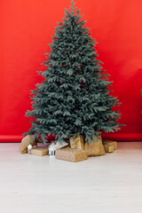 New Year's card interior red decor and Christmas tree with gifts