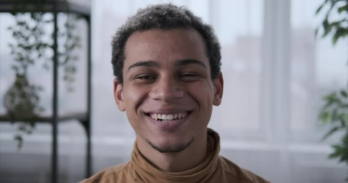 Young african american man smiling at home