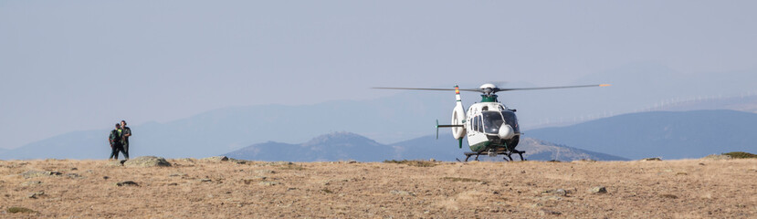 Fototapeta na wymiar Mountain rescue helicopter, people rescue operation.
