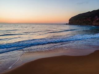 Hazy sunrise seascape with low swell