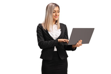 Young professional woman standing and working on a laptop computer