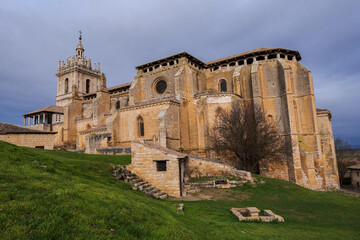 old gothic style catholic church back view with a dramatic sky in palencia, spain