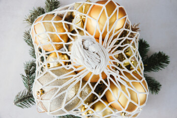 Christmas Decor Golden Baubles in Sting Bag on Table Top View Close Up