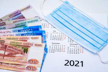 Calendar and Money. Medical mask and calendar on white background.