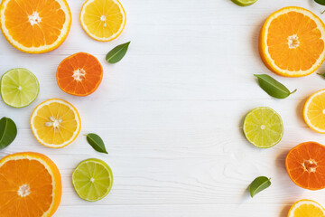Lemons, lime, orange and grapefruit and tangerines cut into circles on a white background with space for text. Poster, banner, article.