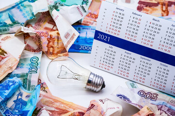Calendar and Money. Crumpled money bills. Money and a light bulb.