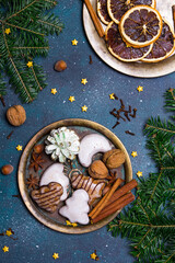 Beautiful Christmas background with decorations. Christmas cookies witch chocolate, gingerbread cookies, nuts and fir twigs on dark background. Copy space for your text