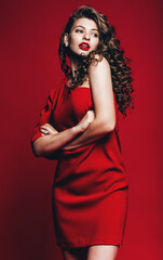 Fototapeta premium sexy beautiful woman in red dress with curly hair