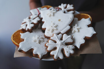 Delicious homemade gingerbread Christmas cookies on a dark background, close-up. Christmas children's menu. 2023