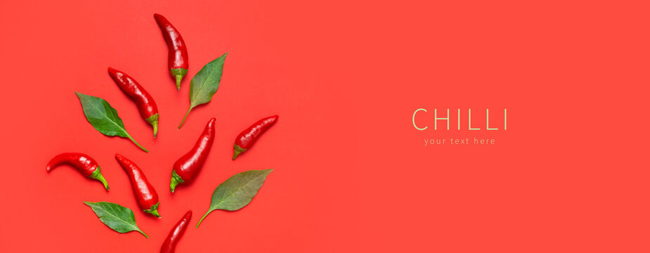 Hot red and green fresh chili peppers on red background flat lay top view copy space. Seasoning for dish, spicy spices for cooking, cayenne pepper, food. Creative layout, chili pattern. Banner