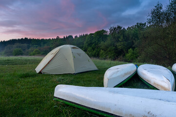 Boat trip with a tent. Rafting on the river by boats. Sunrise. Landscape.