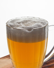 Mug of beer with foam on a white background. Macro
