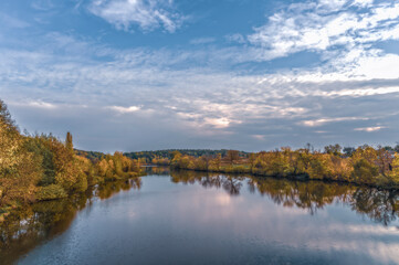 View of the bed of the Rostavitsya river with the banks overgrown with autumn forest. Ukraine