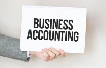businessman holding a card with text business accounting
