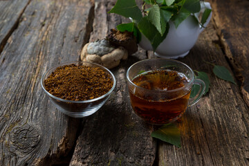 chaga birch mushroom on a dark background. Birch mushroom drink. phytotherapy. Organic superfood.