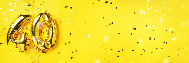 Gold foil balloon number, digit forty. Birthday greeting card, inscription 40. Anniversary celebration event. Banner. Golden numeral, yellow background. Numerical digit, light bokeh, glitter.