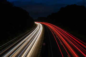 Beautiful and colorful long exposure of the driving cars on the highway at night