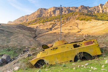 Side of an abandoned war tank with vegetation growing inside close to Shushi in the Republic of Arstakh in Nagorno Karabakh