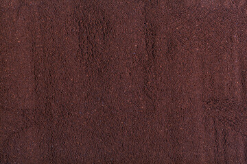 Coffee grind texture background, close up. ground coffee brown background, wood grain texture.