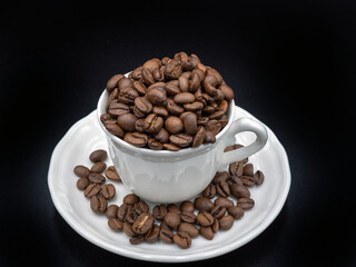 coffee beans in a white cup on the background