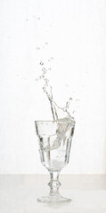 Vintage glass of sparkling water with splashes