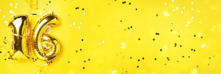 Gold foil balloon number, digit sixteen. Birthday greeting card, inscription 16. Anniversary celebration. Banner. Stylish golden numeral, light bokeh, glitter, yellow background. Numerical digit