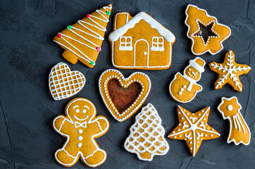 Christmas gingerbread cookies with white icing sugar, on a dark background
