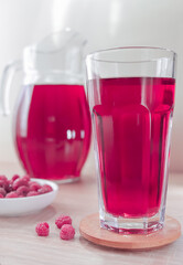 heap ripe raspberry with strawberry fruit , glass juice