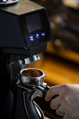 coffee grinder grinding coffee pouring into a portafilter