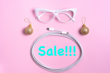 flat set of white items of electronics and accessories on a pink background with Christmas decorations. horizontal photo. With free space to advertise text and logos with sale inscription