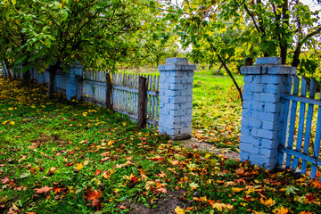 Stone fence. Entrance to the park. Autumn landscapes. 