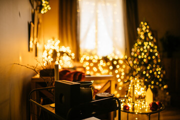 new year cozy home interior with christmas tree and garlands