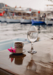 Turkish coffee with a glass of water and a pink flower