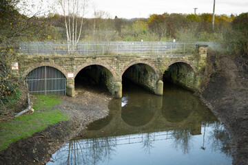 Fototapeta na wymiar Four arched railway bridge over a small river