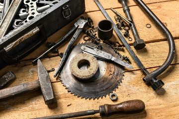 Variety of old vintage household hand tools still life on a wooden background in a DIY and repair concept