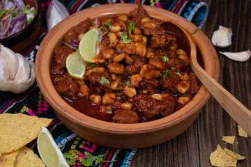 Vegan pozole rojo made with seitan, served in traditional mexican bowl