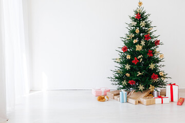 Christmas tree with decorations and gifts interior of the house new holiday white