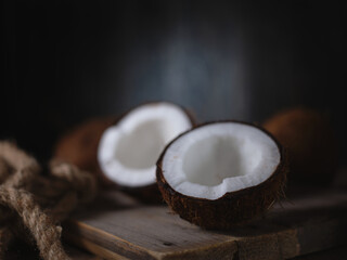Coconuts on the table on a dark background
