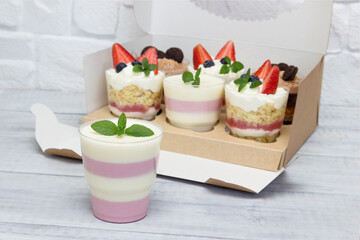 Delicious desserts  in a glass, with chocolate caramel , ganache, creme brulee and  strawberry mint десерт in a gift box.