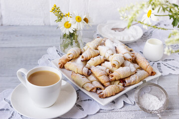 Homemade croissants with apricot jam on the table.