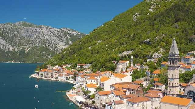 Perast, Montenegro. Aerial top view of the cityscape and St. Nicholas Church 