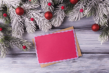 Fototapeta premium Blank red card with envelope and Christmas decoration. Xmas and New Year greeting