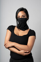 Mixed-Race woman wearing a black gaiter. Studio shot on white.