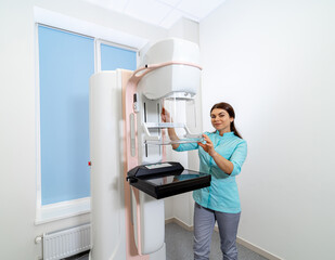 X - ray equipment for breast examination. Mammograph. Woman doctor stands near medical equipment. Closeup.