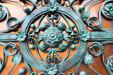 forged metal product. fragments of a forged lattice on the gate
