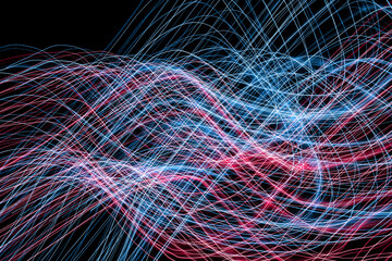 Sinusoidal wave chaos texture. Neon lights background. Motion lines texture. Long exposure moving light pattern. Abstract night life background. Glowing lines design. Colorful illumination.