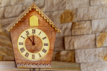 Fototapeta na wymiar Old clock on a wooden light wall. Vintage clock. Cuckoo clock. Copy-space.